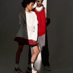 Stylish young couple showcases their love and aesthetic charm amidst dramatic lighting and shadows.