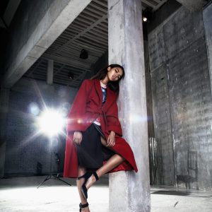 stylish-woman-in-red-coat-posing-in-studio-2026-03-26-06-05-57-utc